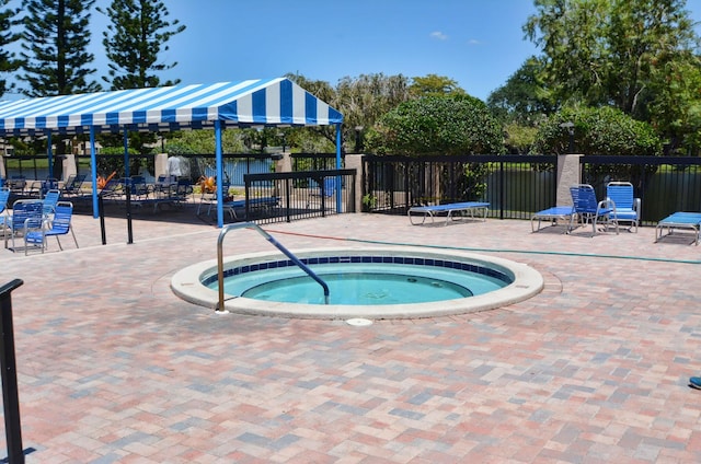 view of swimming pool with a community hot tub