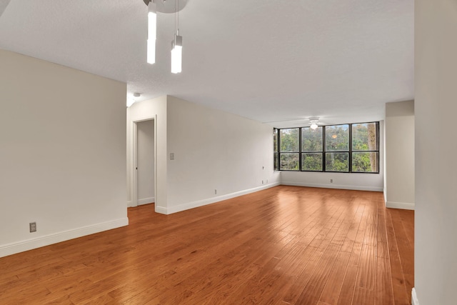 interior space with hardwood / wood-style flooring, ceiling fan, and a textured ceiling