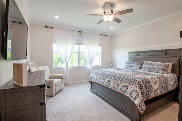 bedroom featuring crown molding, light colored carpet, and ceiling fan