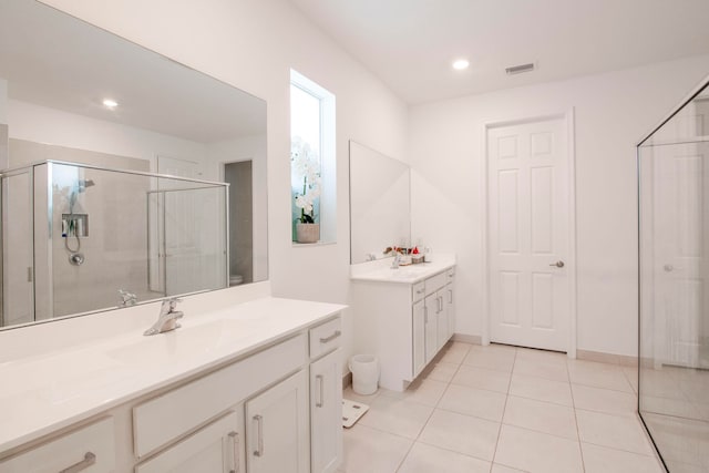 bathroom with vanity, tile patterned flooring, and a shower with door