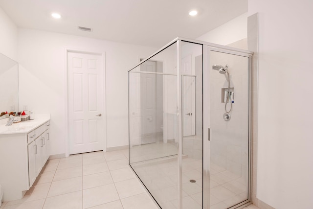 bathroom featuring vanity, tile patterned floors, and walk in shower