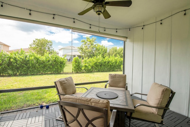 sunroom / solarium featuring ceiling fan