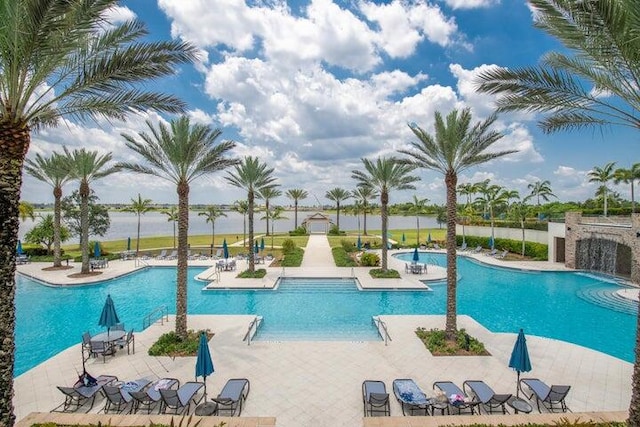 view of pool with pool water feature and a patio