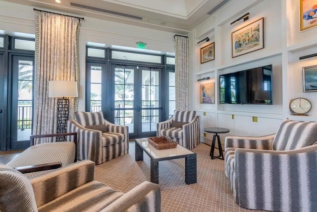 living area with french doors and a towering ceiling