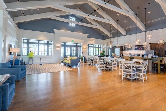 interior space featuring beamed ceiling, hardwood / wood-style flooring, and high vaulted ceiling