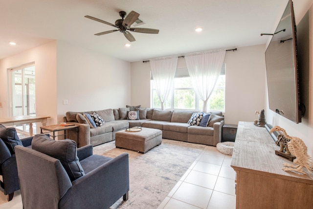 tiled living room with ceiling fan and a wealth of natural light