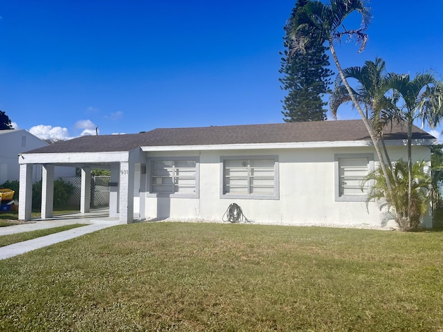 view of front of house with a front yard and a carport