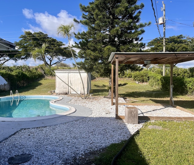 view of pool featuring a storage shed and a lawn