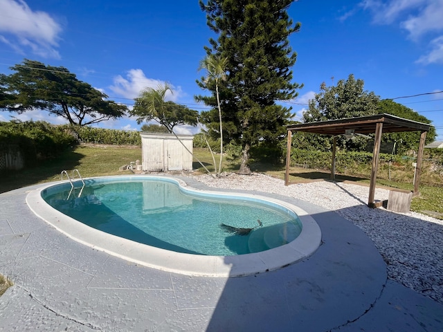 view of pool with a gazebo and a storage shed