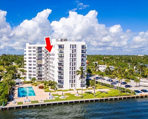 view of property featuring a community pool and a water view