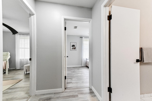 corridor featuring light hardwood / wood-style floors