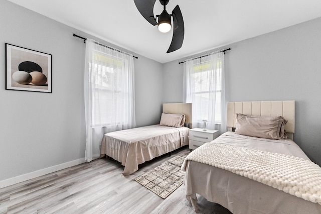 bedroom with ceiling fan and light hardwood / wood-style floors