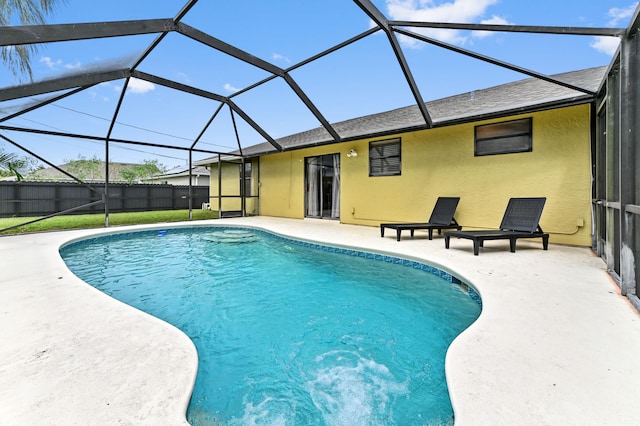 view of pool featuring glass enclosure and a patio