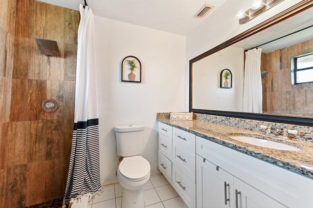 bathroom featuring tile patterned floors, a shower with curtain, vanity, and toilet