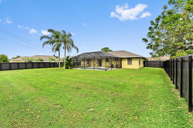 view of yard with a fenced in pool and glass enclosure