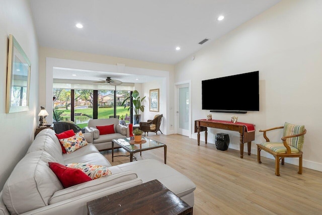 living room with high vaulted ceiling, light hardwood / wood-style floors, and ceiling fan