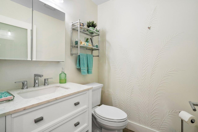 bathroom with vanity and toilet