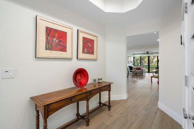 corridor with light hardwood / wood-style flooring