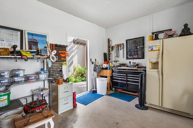 misc room with a workshop area, concrete floors, and a textured ceiling