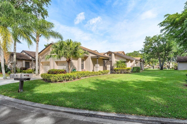 view of front of house with a front yard and a garage