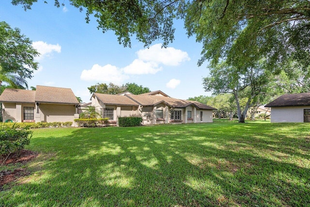 rear view of property with a lawn