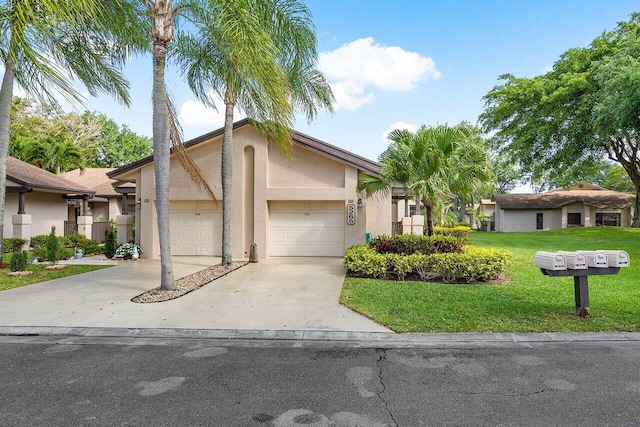 view of front of home with a front lawn and a garage