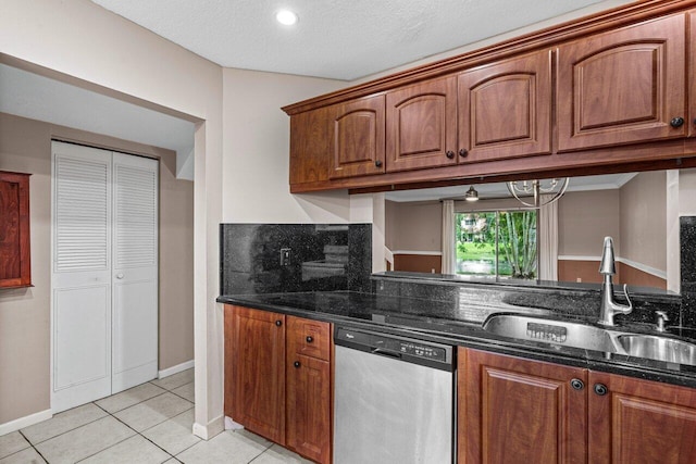 kitchen with sink, light tile patterned floors, white appliances, dark stone counters, and backsplash