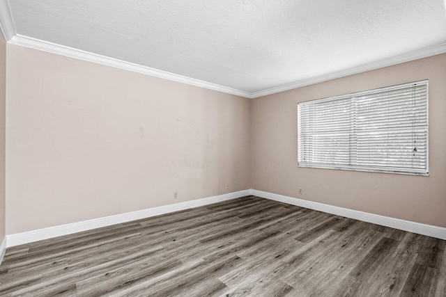 unfurnished room with dark wood-type flooring, ornamental molding, and a textured ceiling