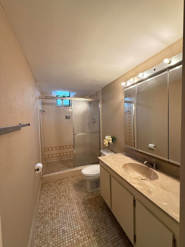 bathroom featuring tile patterned flooring, vanity, toilet, and a shower with shower door