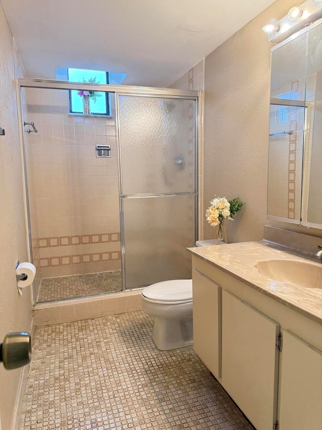 bathroom featuring tile patterned floors, walk in shower, vanity, and toilet