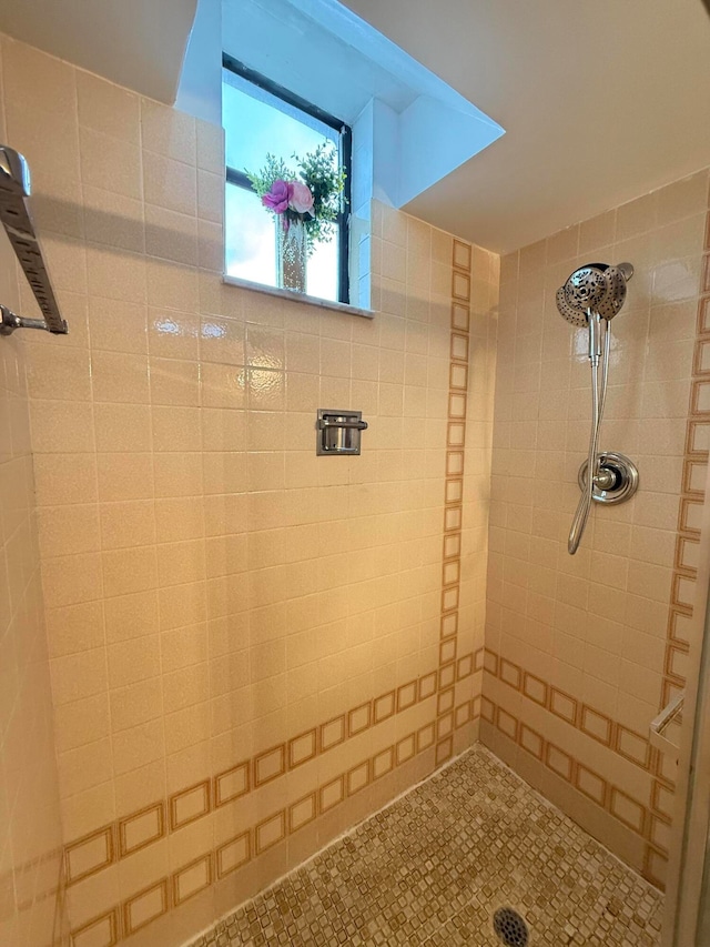 bathroom with tiled shower