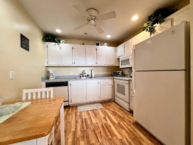 kitchen with white appliances, sink, white cabinets, light hardwood / wood-style floors, and ceiling fan