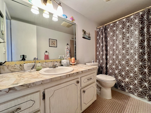 bathroom with vanity, toilet, tile patterned floors, and tile walls