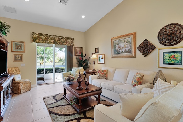 living room featuring high vaulted ceiling and light tile patterned floors