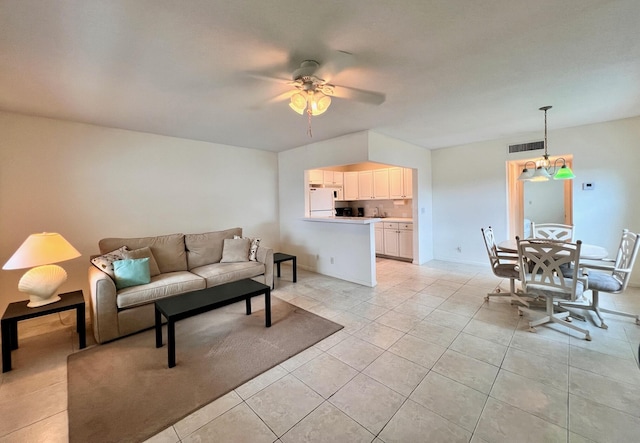 living room with light tile patterned floors and ceiling fan with notable chandelier