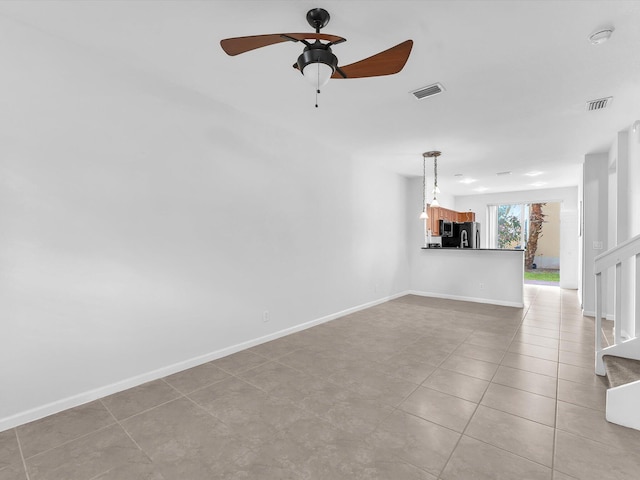 unfurnished living room featuring ceiling fan and light tile patterned flooring