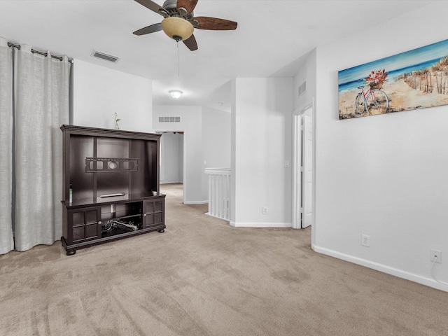 carpeted living room with ceiling fan