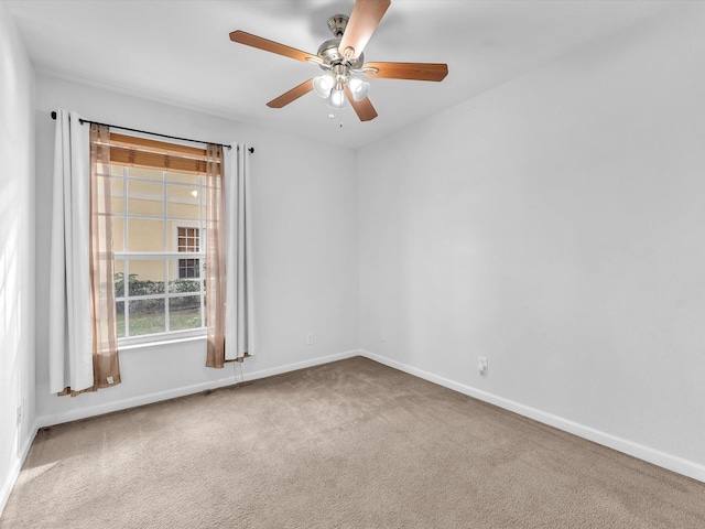 carpeted spare room with ceiling fan