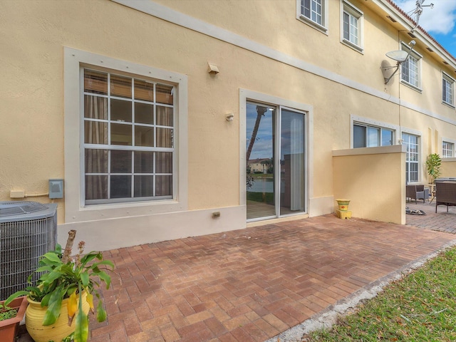 rear view of house with a patio area and central air condition unit