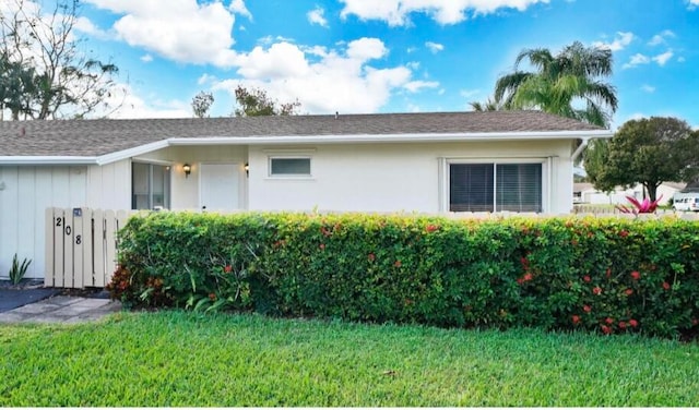 view of side of home with a lawn