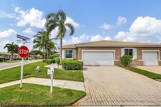 view of front facade with a front yard and a garage