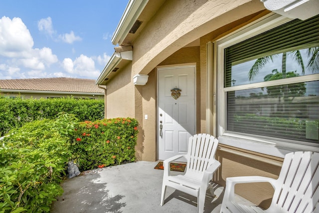 entrance to property with a patio