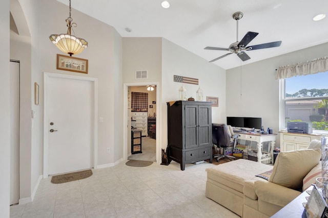 tiled living room featuring ceiling fan and high vaulted ceiling