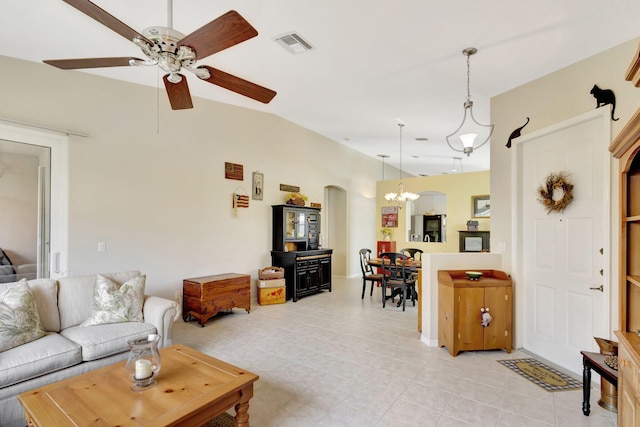 living room with vaulted ceiling, ceiling fan with notable chandelier, and light tile patterned floors