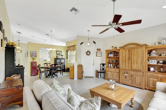 living room featuring vaulted ceiling and ceiling fan with notable chandelier