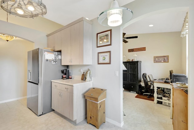 kitchen featuring stainless steel fridge, decorative light fixtures, light tile patterned floors, light brown cabinetry, and ceiling fan