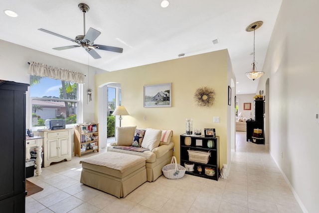 tiled living room with ceiling fan