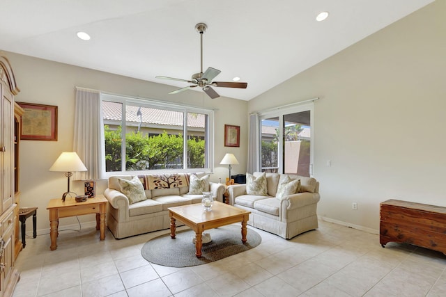 tiled living room featuring ceiling fan and vaulted ceiling