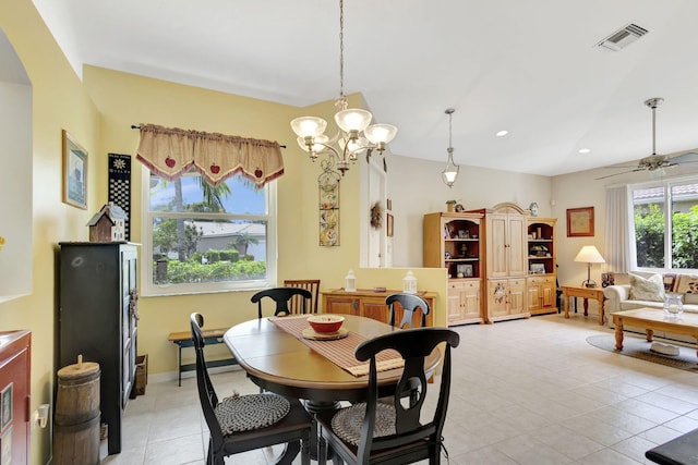 dining room with ceiling fan with notable chandelier and light tile patterned floors