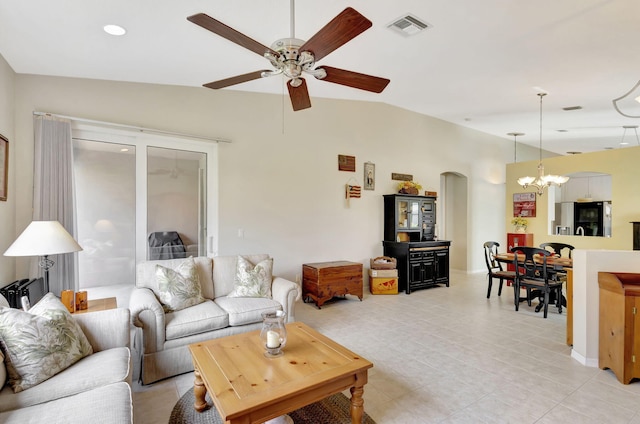 living room with lofted ceiling and ceiling fan with notable chandelier